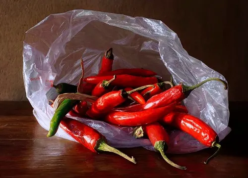 Bright red chili peppers in plastic bag at Festival di Spoleto market
