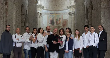 Spoleto Festival di performers posing together in historic stone venue