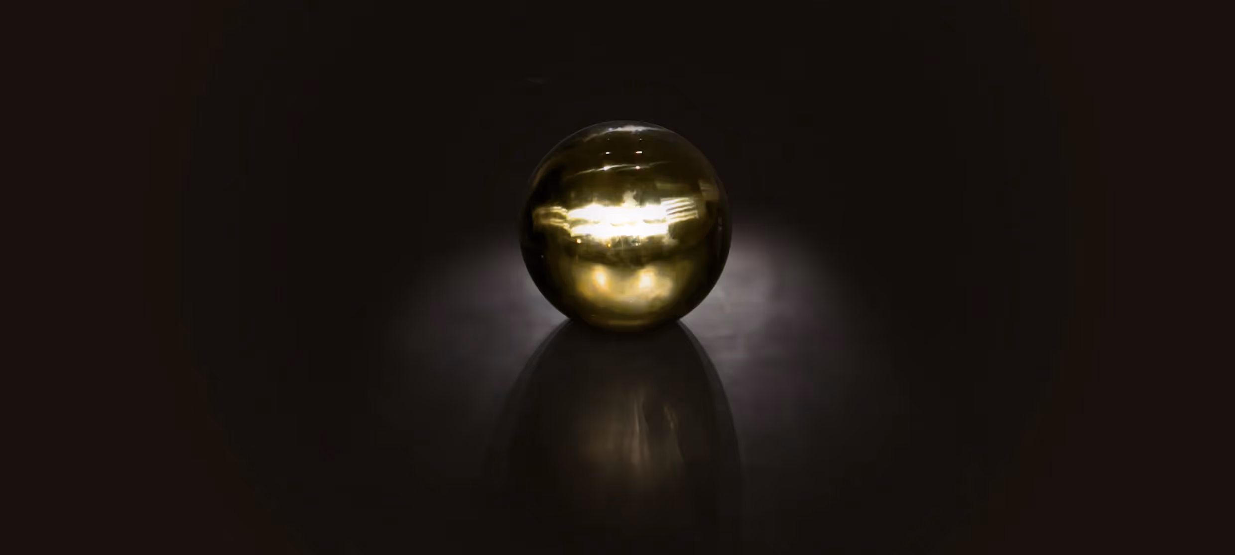 Festival di Spoleto golden orb reflecting light on dark background
