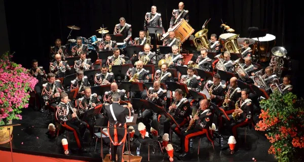 Carabinieri band performs at Festival di Spoleto, surrounded by vibrant flowers