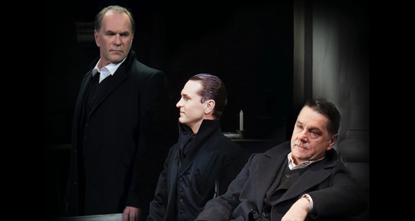Three men in black coats at Festival di Spoleto theatrical performance