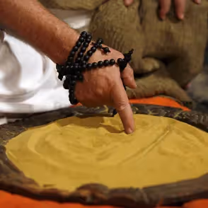 Hand pointing on yellow dough during Festival di Spoleto culinary workshop