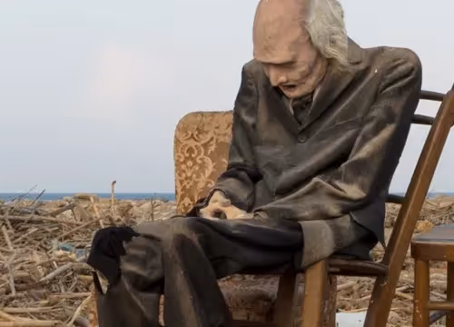 Elderly person sitting alone at Festival di Spoleto, contemplative atmosphere