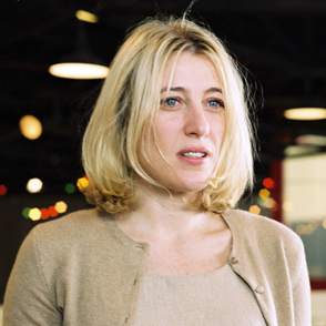 Blonde woman at Festival di Spoleto event with blurred city lights background
