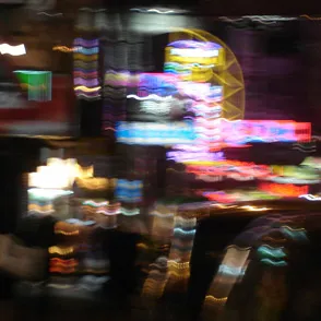 Blurry Festival di Spoleto lights creating colorful, dynamic nighttime street scene