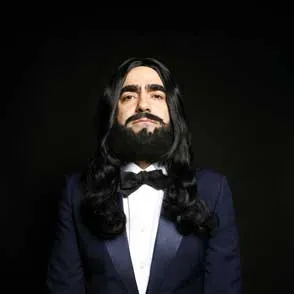 Performer in tuxedo at Festival di Spoleto, long hair and dramatic pose