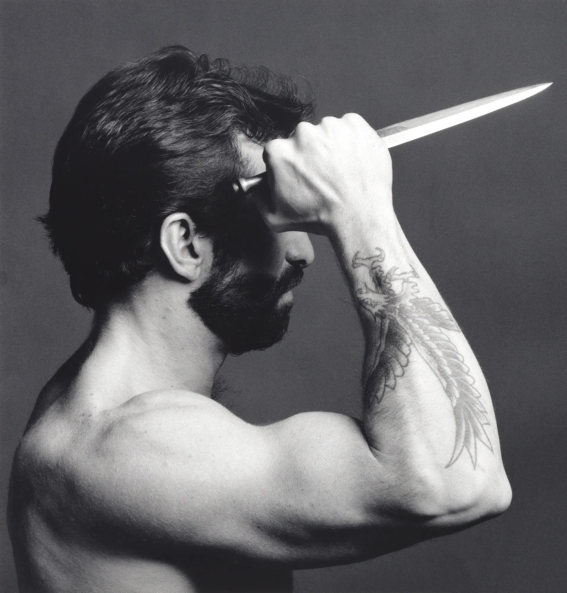 Festival di Spoleto artistic portrait of muscular man with knife and tattoo