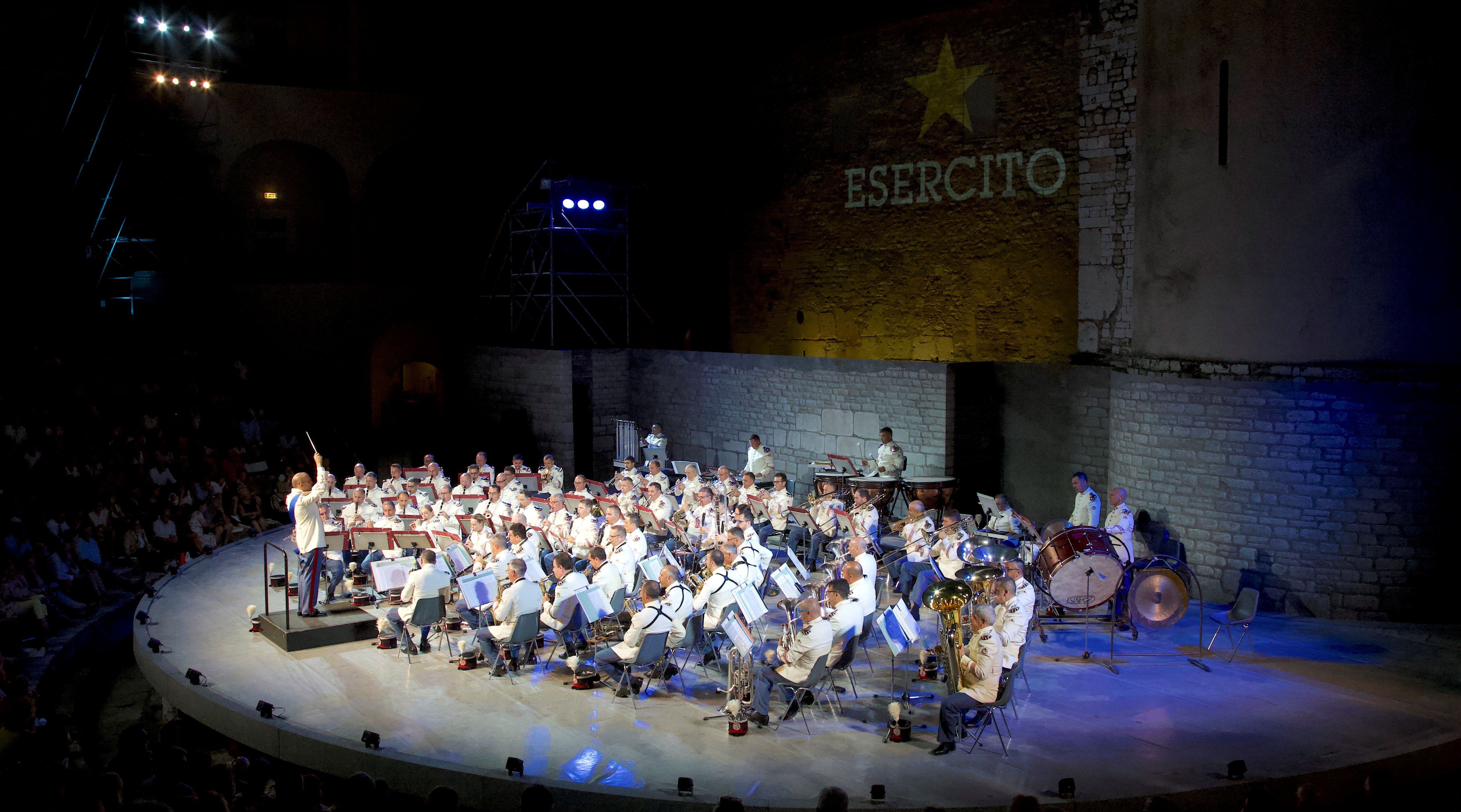 Military band performing at Festival di Spoleto on circular stone stage