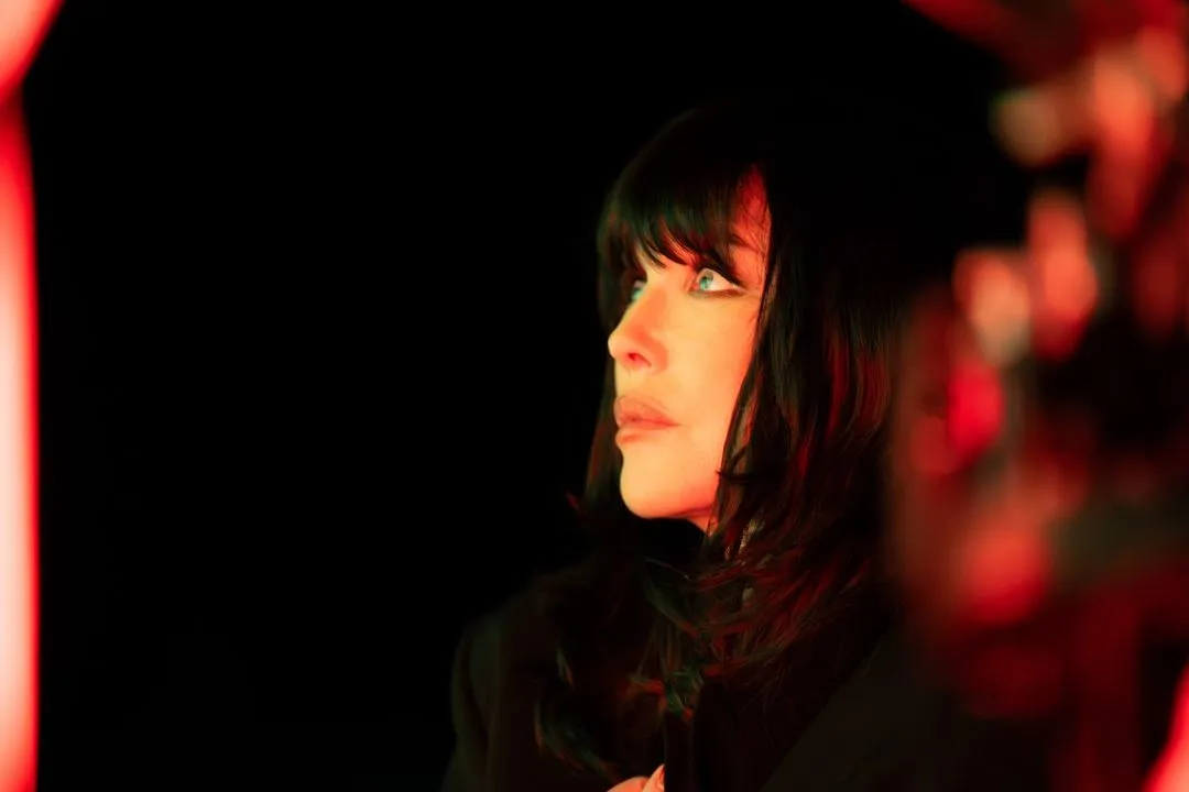 Performer in dramatic red lighting at Festival di Spoleto artistic event