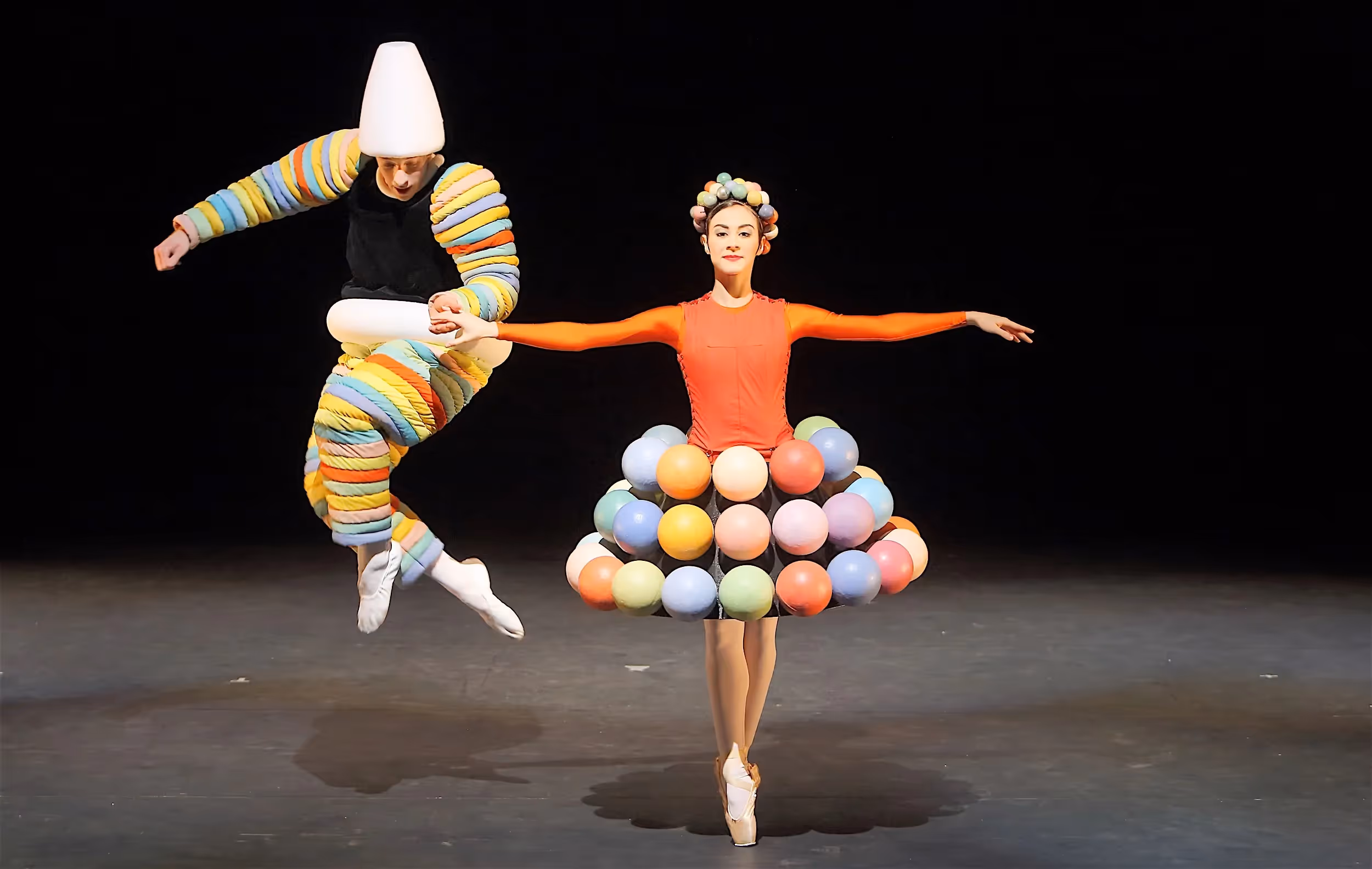 Colorful dancers at Festival di Spoleto with whimsical balloon-inspired costumes