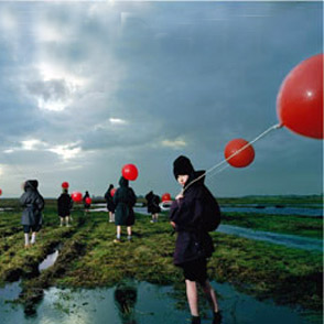 Festival di Spoleto performers with red balloons standing in misty marshy landscape