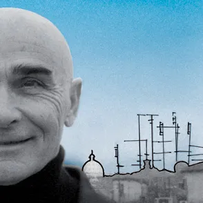 Smiling man at Festival di Spoleto with industrial skyline background