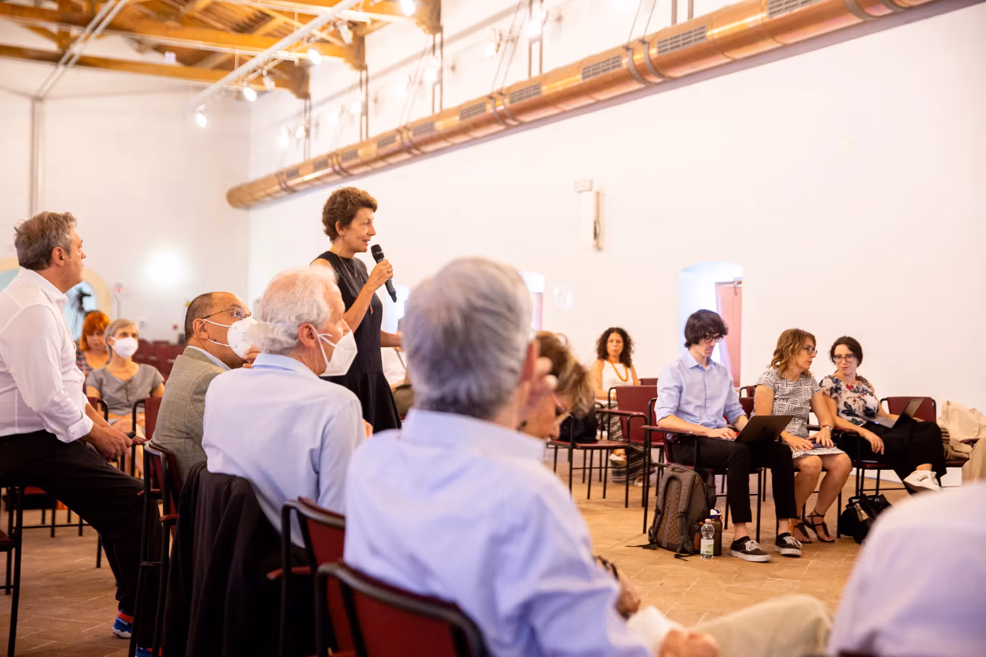 Festival di Spoleto conference with speaker addressing audience in meeting room