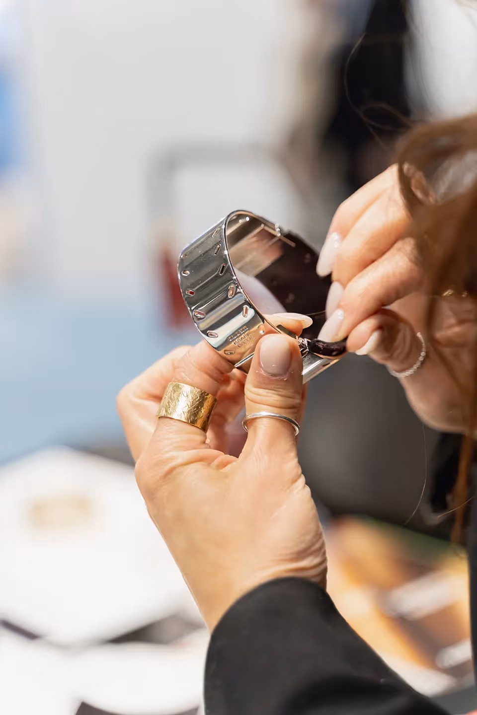 Backstage detail at Festival di Spoleto, hands adjusting metallic accessory