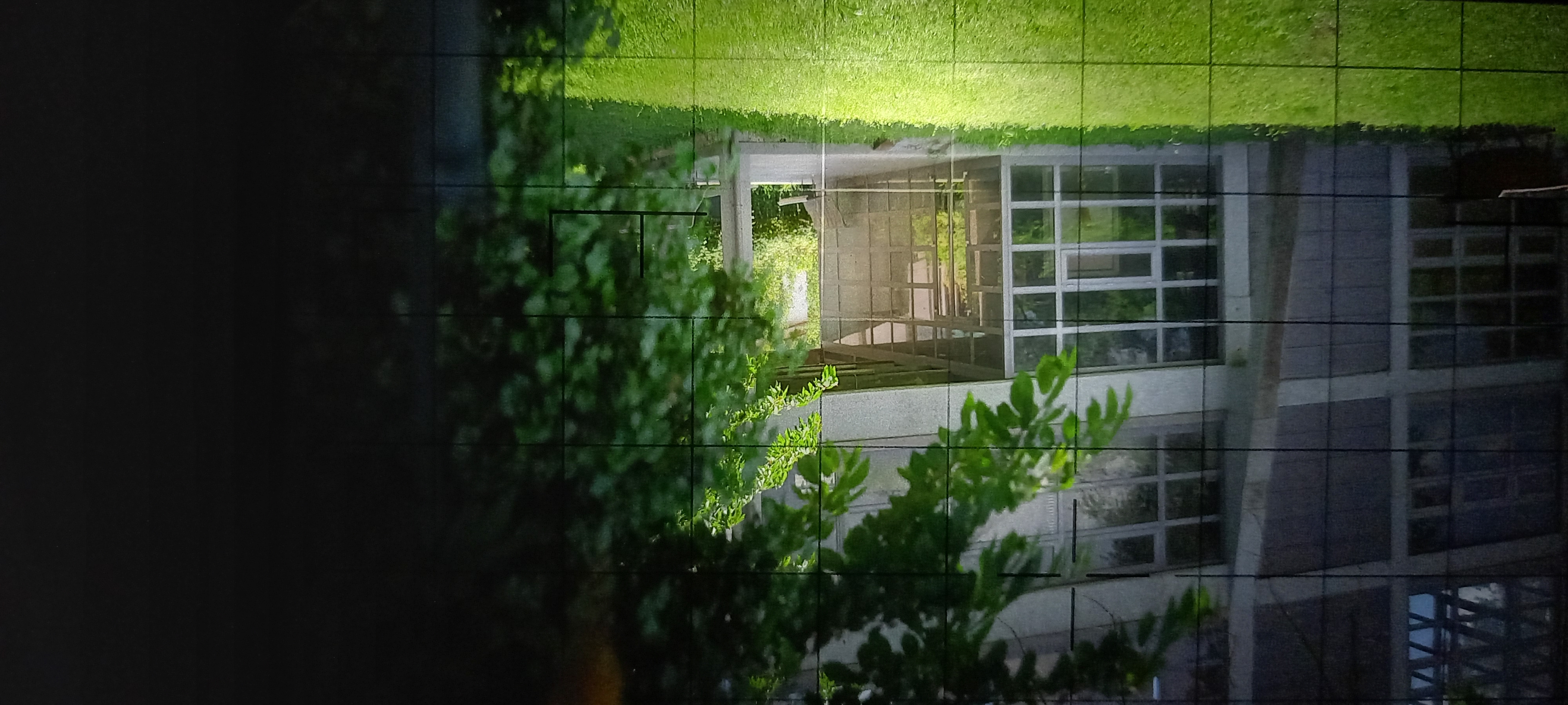 Modern glass building at Festival di Spoleto with lush green foliage