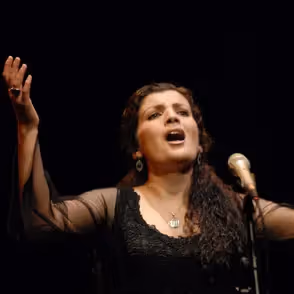 Passionate singer performing at Festival di Spoleto, dramatic black background