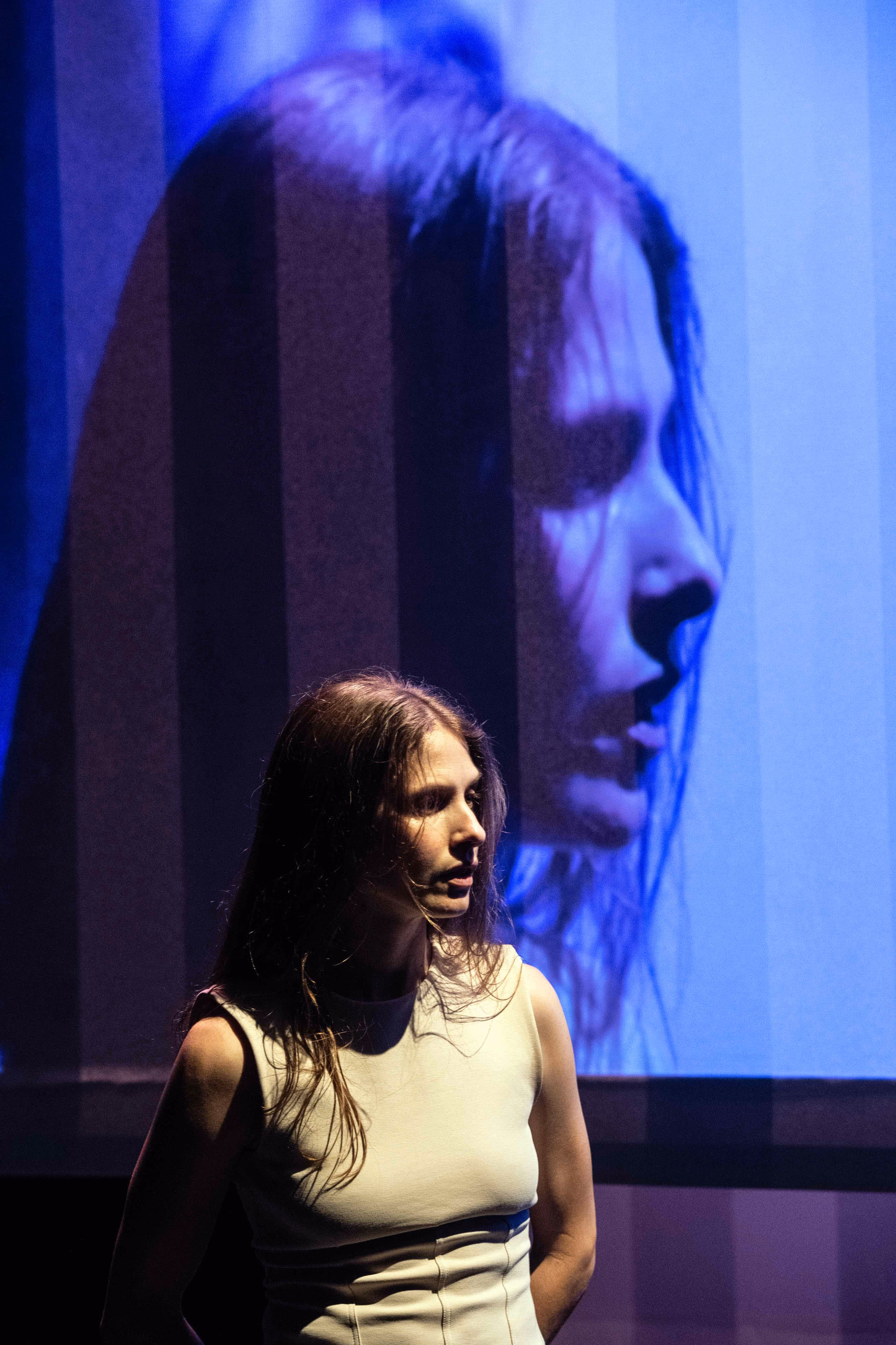 Performance at Festival di Spoleto with dramatic blue-lit stage backdrop