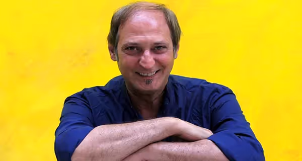 Smiling man in blue shirt at Festival di Spoleto promotional photoshoot