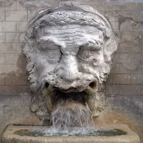 Water flows from stone lion fountain at Festival di Spoleto cultural event