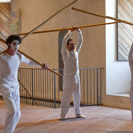 Performers rehearsing with long poles at Festival di Spoleto dance performance