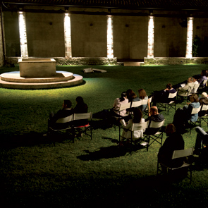 Festival di Spoleto outdoor concert with illuminated pillars and seated audience