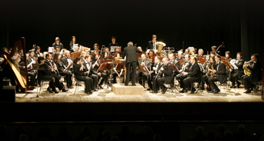 Symphonic orchestra performing at Festival di Spoleto, musicians in formal attire