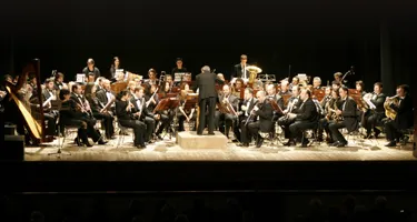 Symphonic orchestra performing at Festival di Spoleto, musicians in formal attire