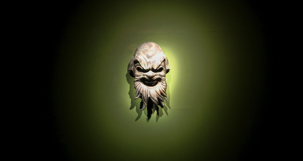 Festival di Spoleto theatrical mask sculpture with dramatic green lighting