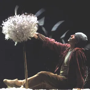 Performer at Festival di Spoleto holding large fluffy dandelion-like prop
