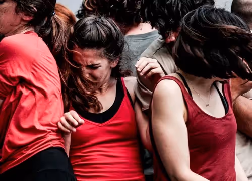 Emotional performers at Festival di Spoleto, dancers embracing in red and black