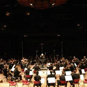 Orchestra performing at Festival di Spoleto with conductor on wooden stage