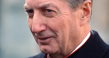 Festival di Spoleto attendee in formal attire looking contemplative