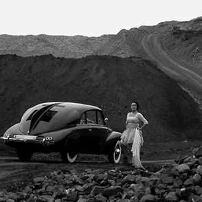 Festival di Spoleto vintage car photoshoot on rocky terrain with elegant model