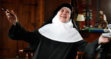 Joyful nun smiling at Festival di Spoleto, gesturing with enthusiasm