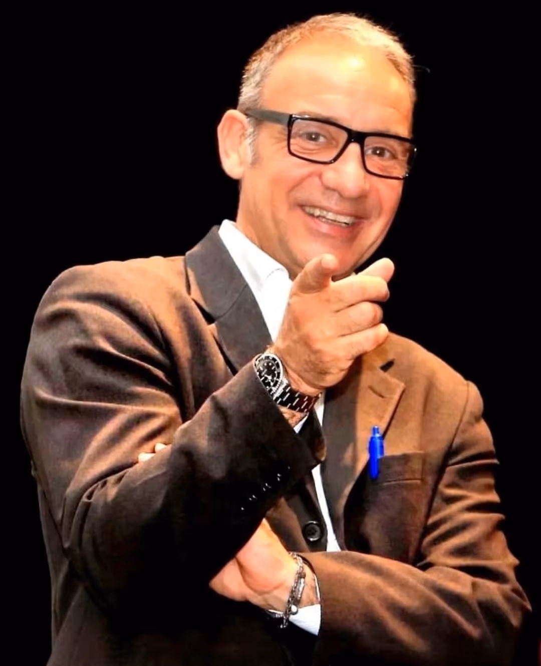 Smiling person at Festival di Spoleto, gesturing enthusiastically on stage