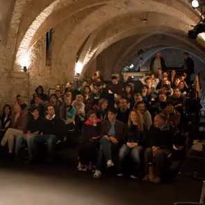 Festival di Spoleto audience seated in historic stone-arched venue