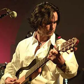 Musician playing acoustic guitar at Festival di Spoleto music event