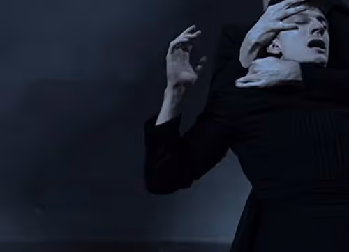 Dramatic performance at Festival di Spoleto, dark stage, expressive theatrical gesture