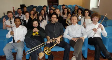 Musicians pose together at Festival di Spoleto, showcasing diverse musical instruments