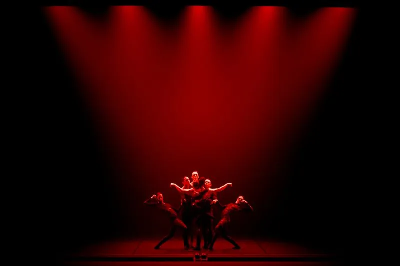 Festival di Spoleto performance with dancers bathed in dramatic red stage light