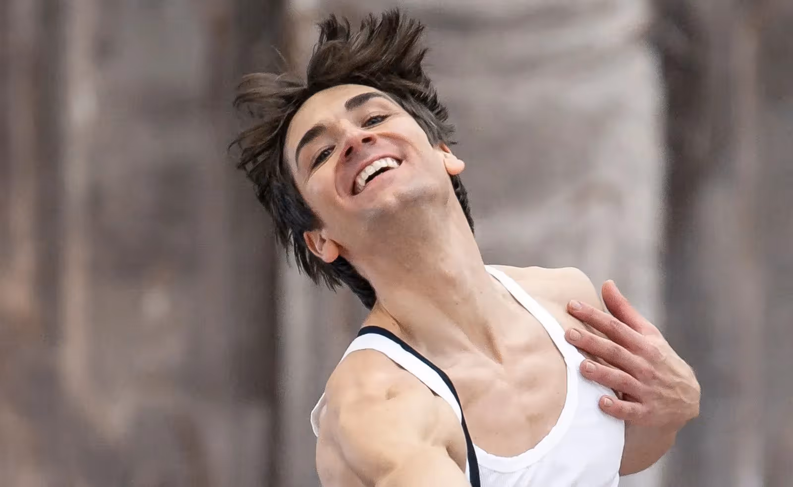 Expressive artist portrait of dancer with messy hair laughing joyfully