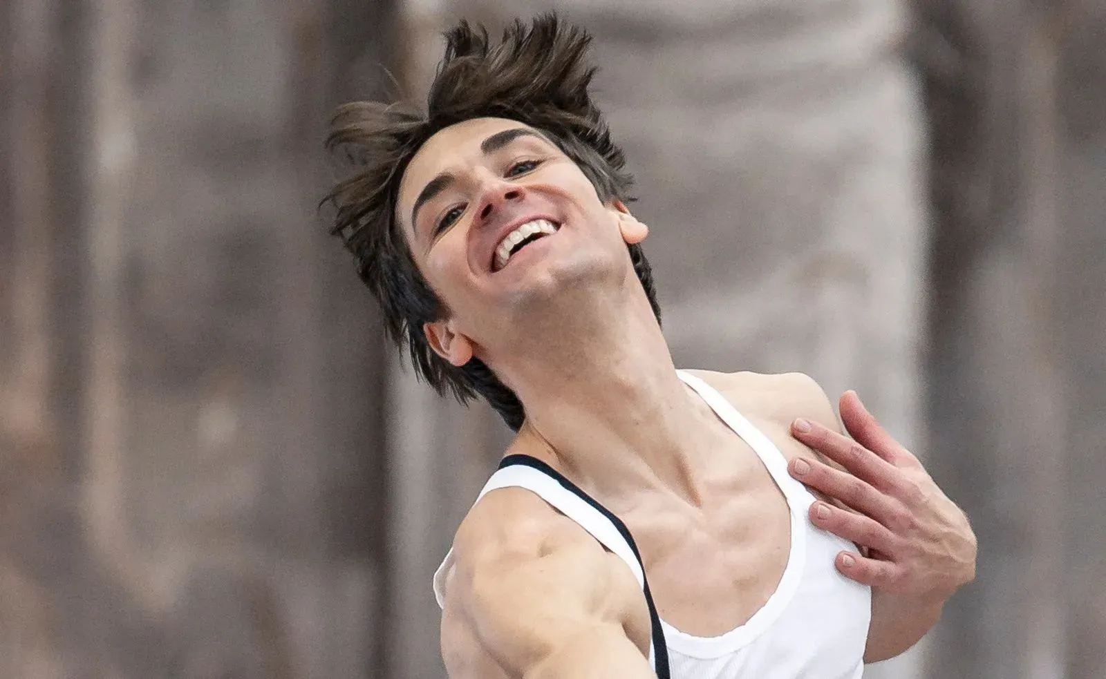 Expressive artist portrait of dancer with messy hair laughing joyfully