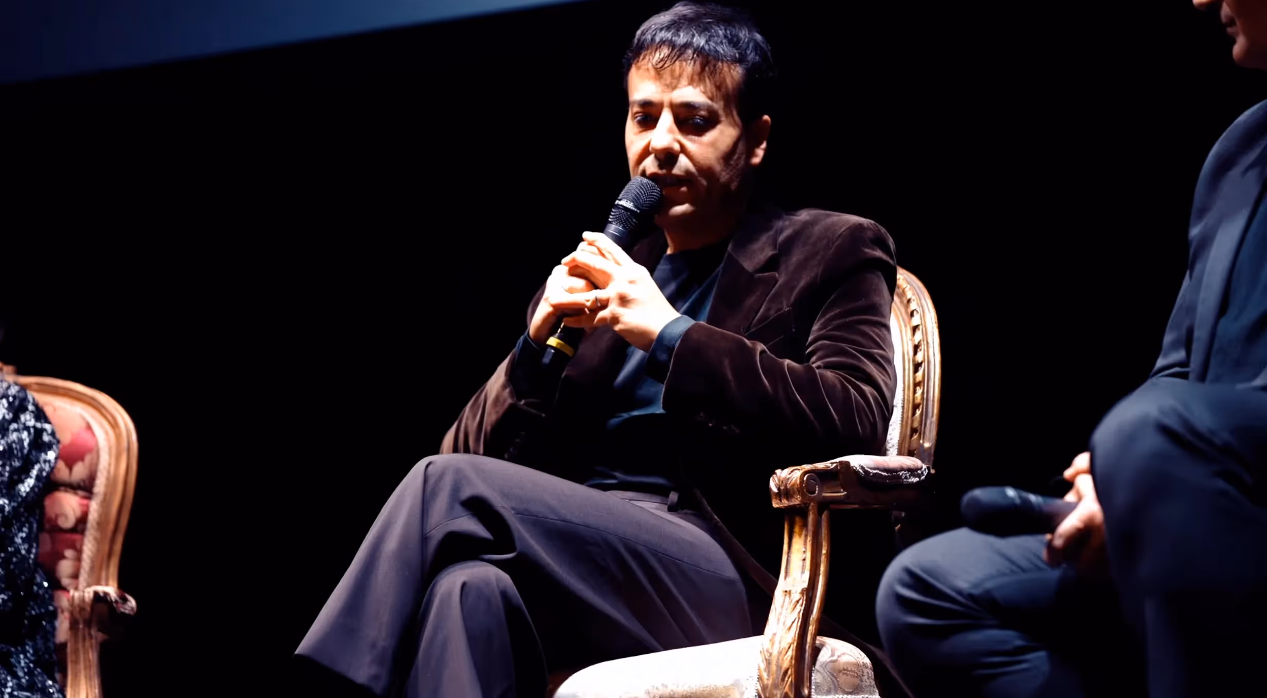 Video interview at Festival di Spoleto, speaker sits on ornate chair