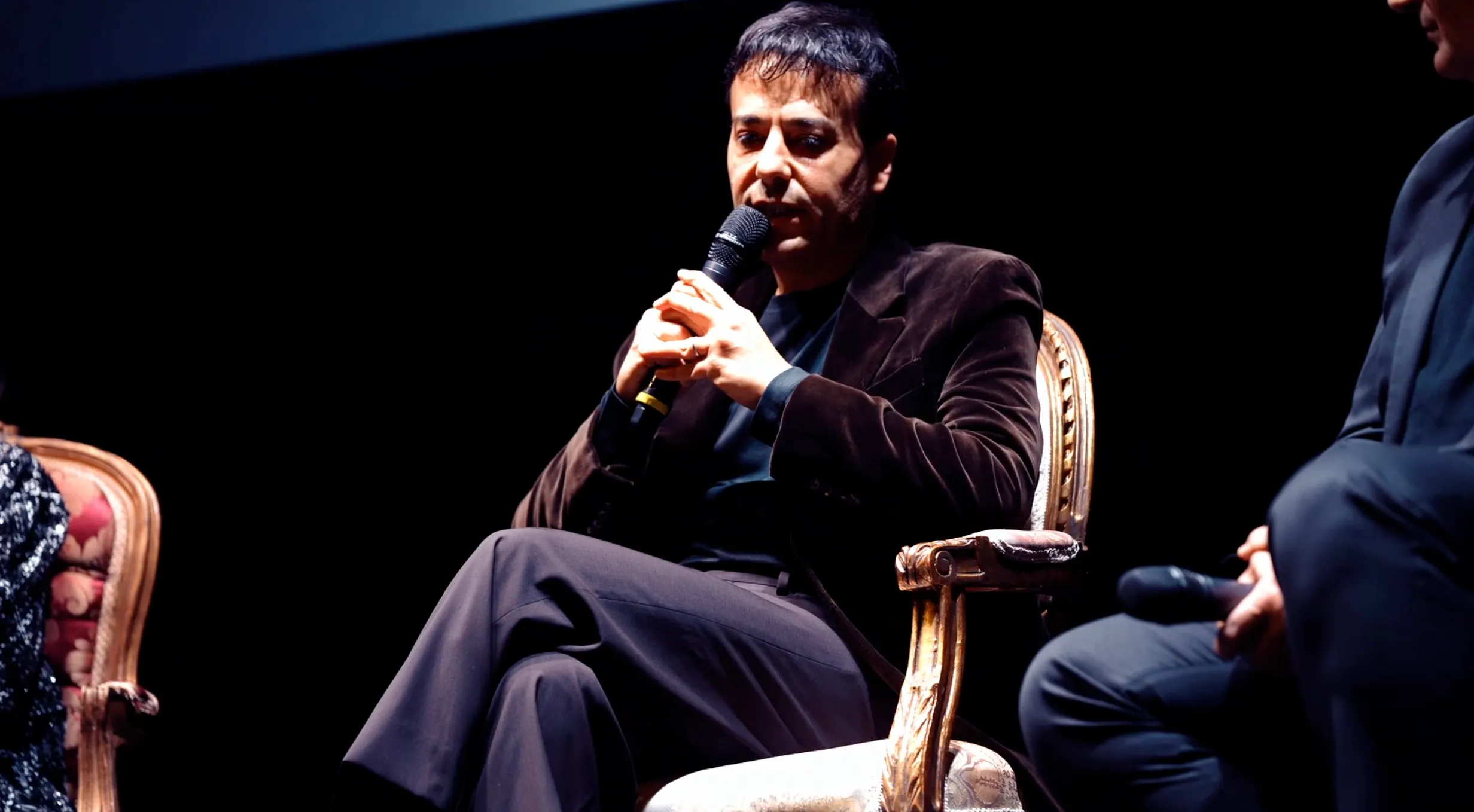 Video interview at Festival di Spoleto, speaker sits on ornate chair