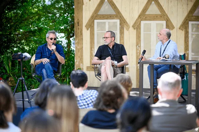Video Festival di Spoleto panel discussion with three speakers on outdoor stage