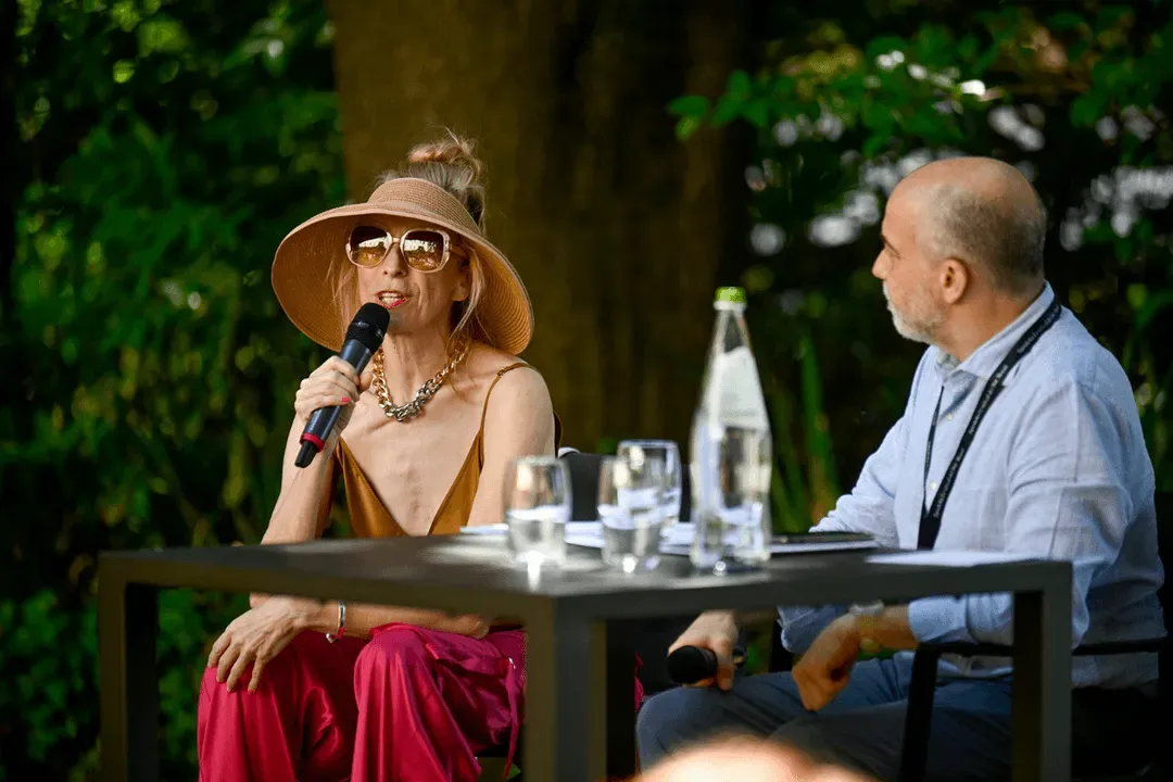 Video Festival di Spoleto, woman in hat speaking at outdoor panel discussion