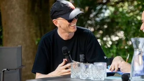 Smiling performer at Video Festival di Spoleto speaking with microphone