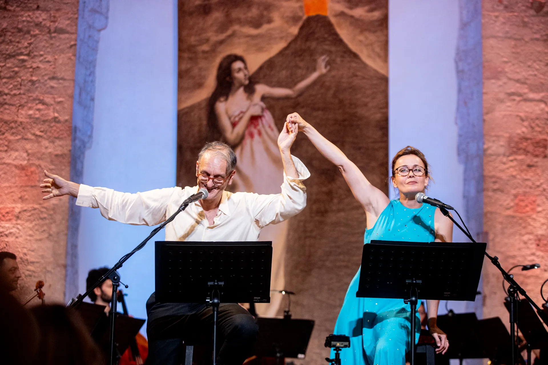 Performers at Festival di Spoleto, theatrical stage with musicians and dramatic backdrop