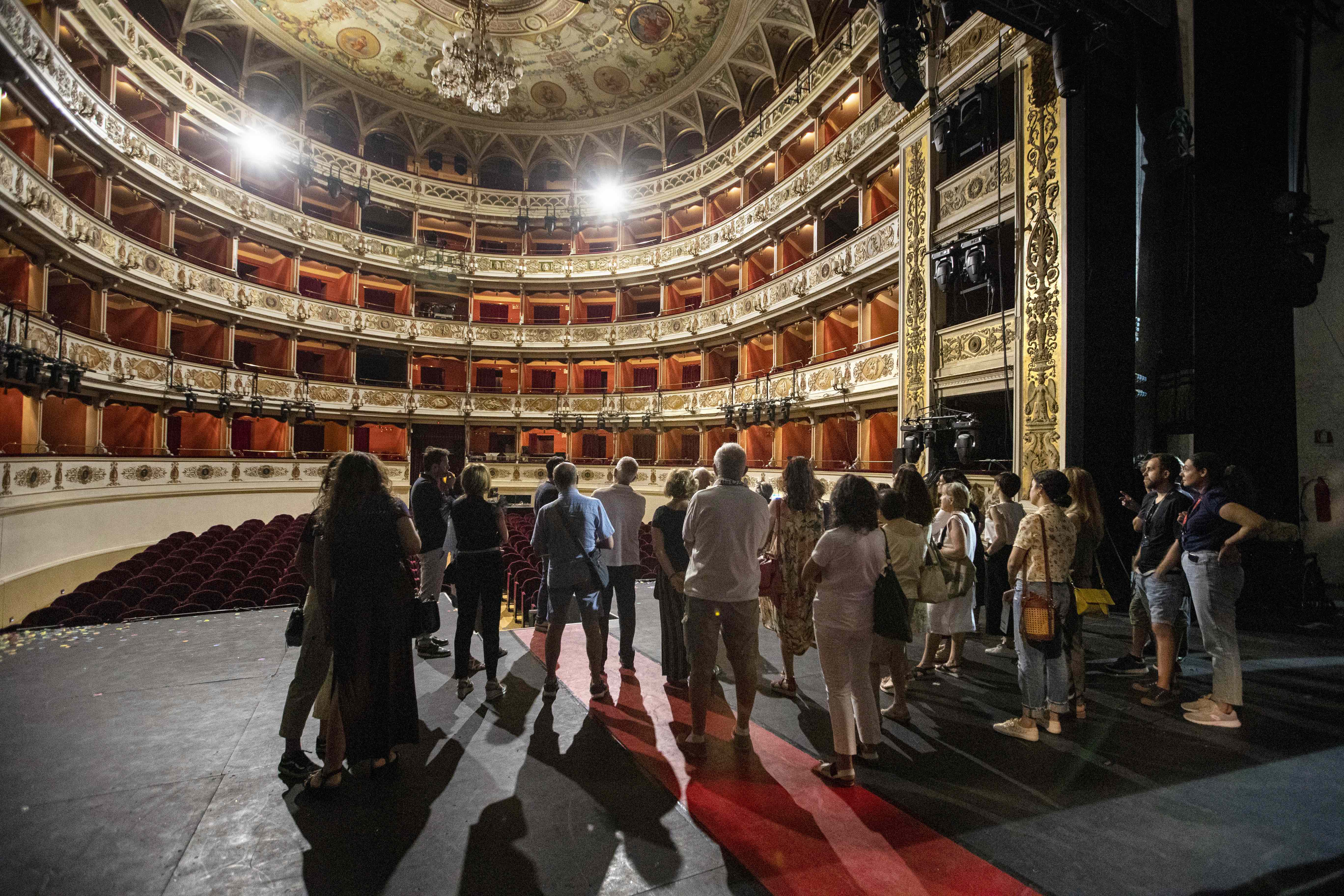 Festival di Spoleto visitors touring historic theater with ornate interior