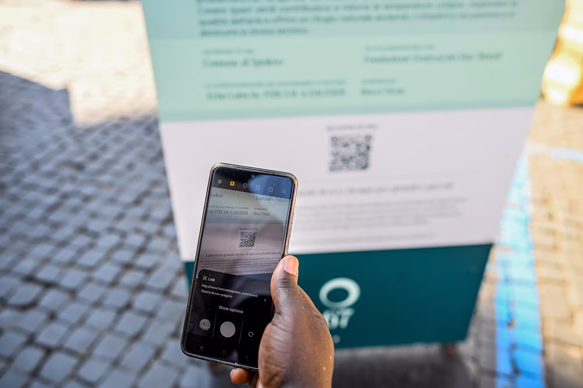 Scanning QR code for Festival di Spoleto event information on mobile phone